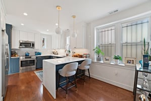 Beautifully renovated kitchen illustrating the use of layered lighting -- a current design trend