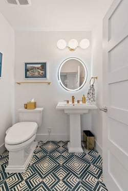 A bathroom with beautiful tile and other decor matching the lighting fixture installed by Wilcox Electric DC