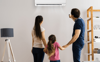 A family looks on as the airconditioning is adjusted with a SMART device installed by Wilcox Electric DC