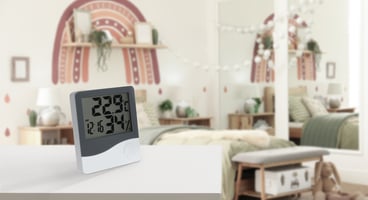 A digital temperature and humiditiy gauge measures conditions a child's room. Wilcox Electric DC