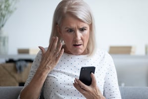 woman-suspicious-of-fraudulent-phone-call