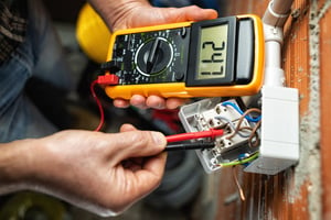 View of electricians hands working with a voltage meter Wilcox Electric DC